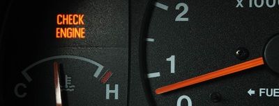 Check engine warning light lit on a dashboard
